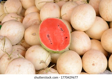 Half cut watermelon on Half cut stack pile at the market
