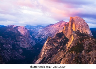 Half Dome Rock Yosemite National Park at Sunset.  Pink sky and clouds.