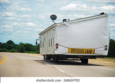 Half Of Double Wide Modular Home Being Transported Along Interstate Highway.