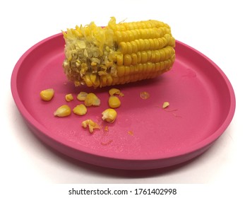 Half Eaten Corn On A Pink Plate