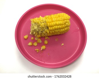 Half Eaten Corn On A Pink Plate