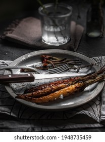 Half Eaten Dinner Baked Carrots With Soft Cheese And Spices On Plate.