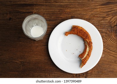 Half Eaten Simit, Left Over Turkish Bagel And A Dirty Glass, Ayran, Wooden Table