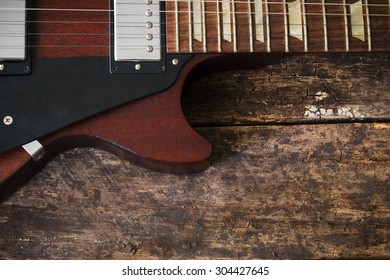 half electric guitar on a wooden background