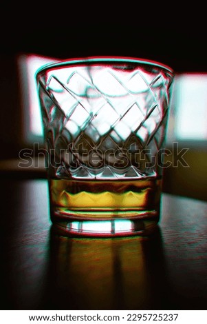 Half empty glass of whiskey drink with chromatic aberrations