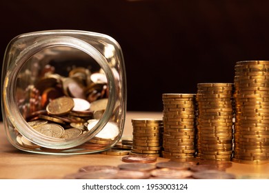 A Half Empty Jar Of Coins With Coin Piles And More Coins On A Table. Save Money Concept Banner