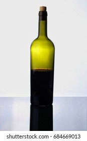 Half Empty Red Wine Bottle Isolated On White Background