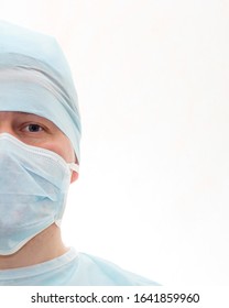 Half Face Portrait Of Surgeon In Sterile Surgical Mask And Medical Cap