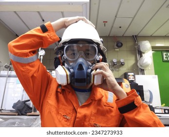 Half Facepiece Reusable Respirator, protect from vapor toxic from chemicals. Worker Prepare to wear a chemical mask. - Powered by Shutterstock