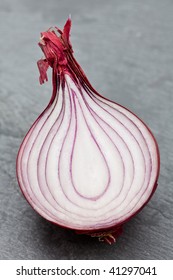 Half A Fresh Red Onion On A Slate