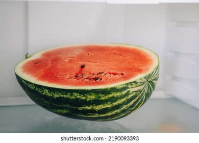 Half Of Fresh Sliced Watermelon On A Shelf In The Refrigerator. Authentic Lifestyle. Home Cooking, Preparation Of Organic Food.