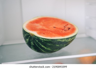 Half Of Fresh Sliced Watermelon On A Shelf In The Refrigerator. Authentic Lifestyle. Home Cooking, Preparation Of Organic Food.