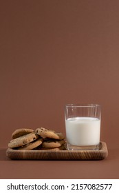 Half Full Glass Of Milk With Fragrant Cookies On A Wooden Stand