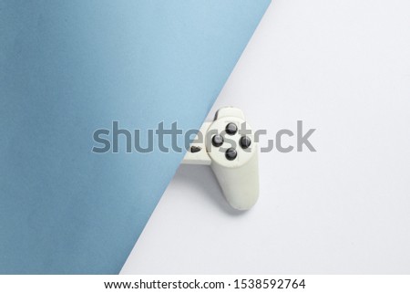 Half gamepad  on blue-gray background. Retro style 80s. Top view