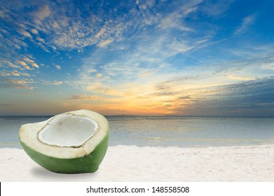 Half Green Coconut On White Sand Beach In Thailand