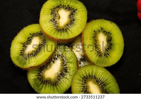  half kiwi fruit  isolated onblack background