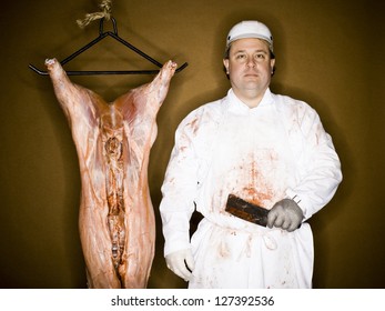 Half length of a butcher with hanging carcass and knife over brown background - Powered by Shutterstock