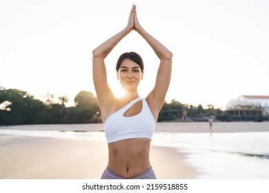 Half Length Of Calm Caucasian Female Yogi Breathing During Nature Mediation At Coastline, Beautiful Woman Spending Time For Holistic Retreat And Healing During Yoga Practice In Namaste Outdoors