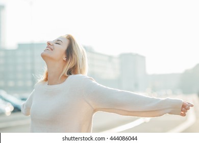 Half Length Of Young Beautiful Cacuasian Woman Feeling Free With Arms Wide Open In The City Back Light - Liberty, Freedom, Girl Power Concept