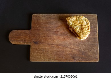 Half A Meat Pasty On A Wooden Board 