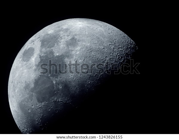 Half\
moon / The Moon is an astronomical body that orbits planet Earth\
and is Earth\'s only permanent natural satellite. It is the\
fifth-largest natural satellite in the Solar\
System