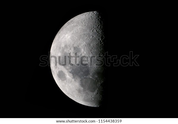 Half moon background / The Moon is an astronomical\
body that orbits planet Earth and is Earth\'s only permanent natural\
satellite. It is the fifth-largest natural satellite in the Solar\
System