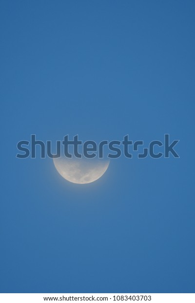 Half moon in blue sky ,evening moon in Thailand.moon
background .