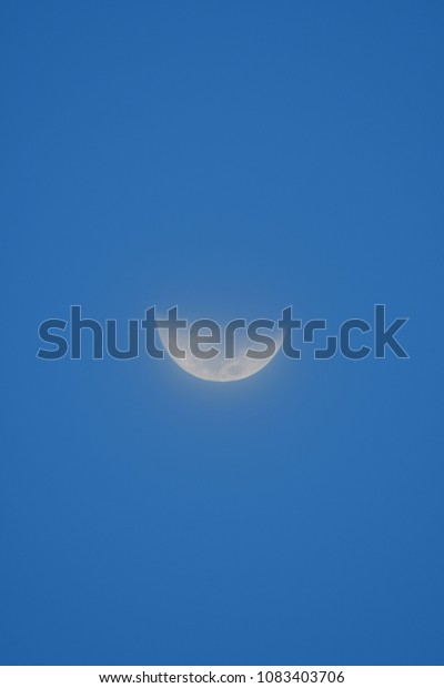 Half moon in blue sky ,evening moon in Thailand.moon\
background .