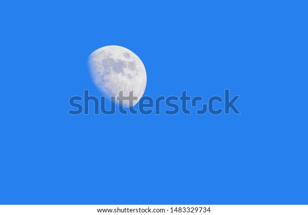Half moon and blue sky
without clouds.