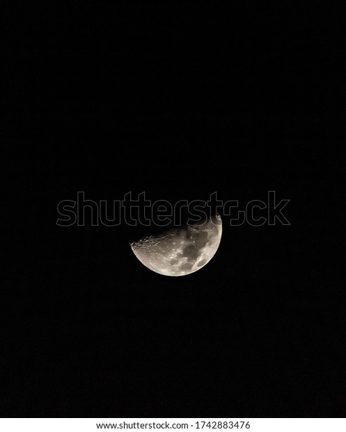 Half moon\
captured in the middle of the\
night