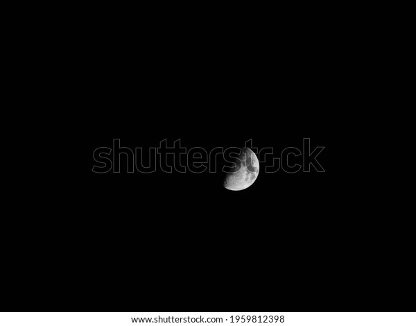 Half moon during the first quarter\
phase isolated against a black\
sky.\
Date:2021-04-21