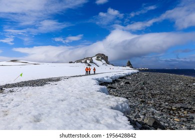 Half Moon Island, South Shetland Islands, Antarctica - 12 05 17: Expedition Polar Cruise Tourists Exploring Antarctic Scenery On A Hike Along The Snowy Shore Of Half Moon Island On An Icy Marked Route