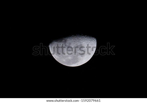 Half moon in the middle of its way The Moon is an\
astronomical body that orbits planet Earth being Earth\'s only\
permanent natural