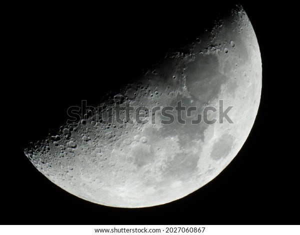 half moon shining\
on earth black background