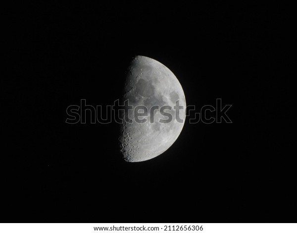  A half moon with a\
textured surface.