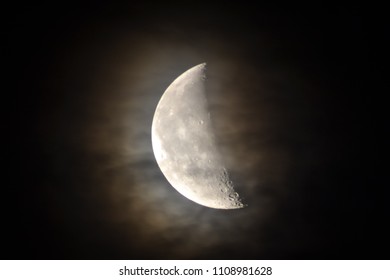 Half moon through clouds