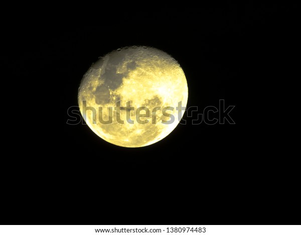Half Moon, waning moon, gibbous moon in the\
middle of its way on the clear\
sky.