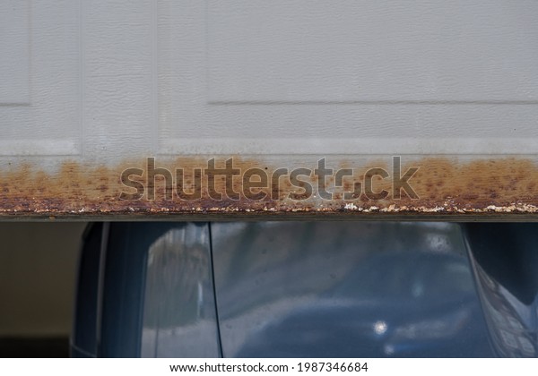 Half opened Garage
door with rust at bottom
