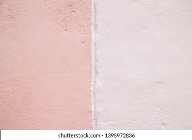 Half Painted Two Color (pastel Pink And Cream) With Textured Concrete Wall In The Background.