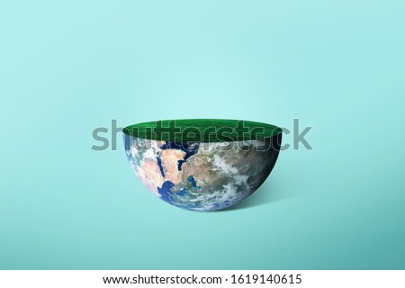 Half of the planet Earth with grass on a green background. Concept of the ecology of the planet. Creative idea 