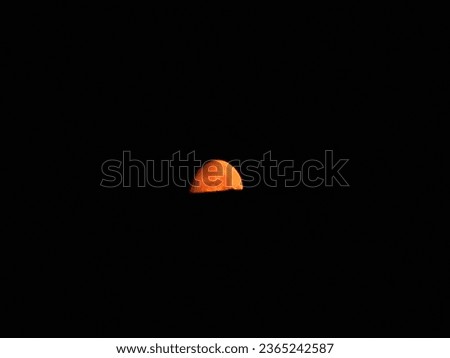 Half red moon against black background