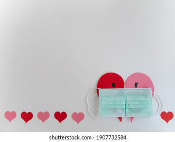 Half of red and pink hearts which use surgical or medical mask to symbolize a couple who love and care each other’s for background use. It's focuses on hygiene on COVID-19 and Valentine's day concept.