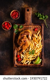 Half roasted chicken Piri Piri with french fries, top view