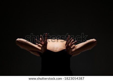 Similar – Close up front portrait of one young middle age athletic woman in sportswear in gym over dark background, standing in boxing stance with hands and fists, looking at camera