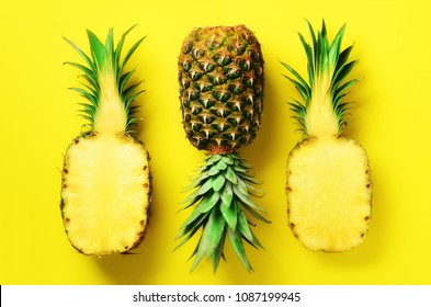 Half Slice Of Fresh Pineapple And Whole Fruit On Yellow Background. Top View. Copy Space. Bright Pineapples Pattern For Minimal Style. Pop Art Design, Creative Concept