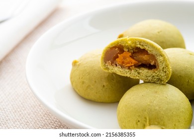 Half Sliced Mochi Cakes With Durian And Salted Egg Filling On White Plate