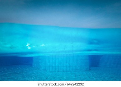 Half Underwater Shot, Clear Turquoise Water On Swimming Pool And Clear Sky.