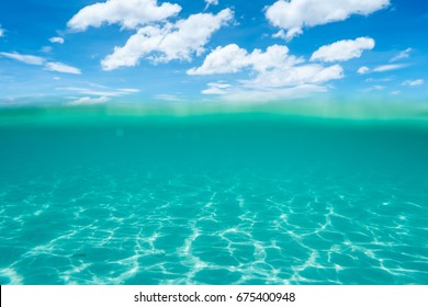 Half Underwater Shot, Clear Turquoise Water And Sunny Blue Sky. Tropical Ocean