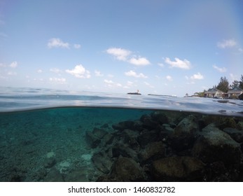 Half Underwater Shot With Fishes And Water Villas