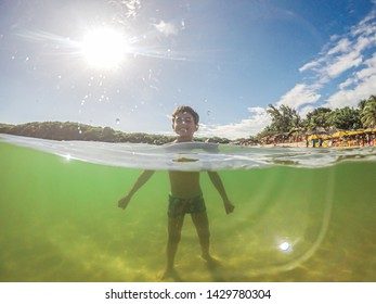 Half Underwater Shot Of Happy Smiling Boy. Child Boy In The Water On A Lake.